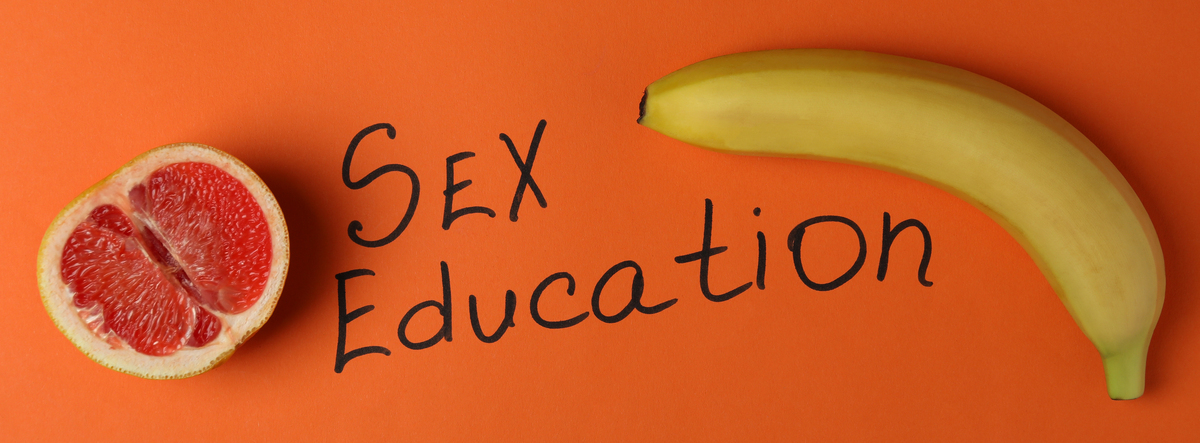 sex education concept on orange background, top view