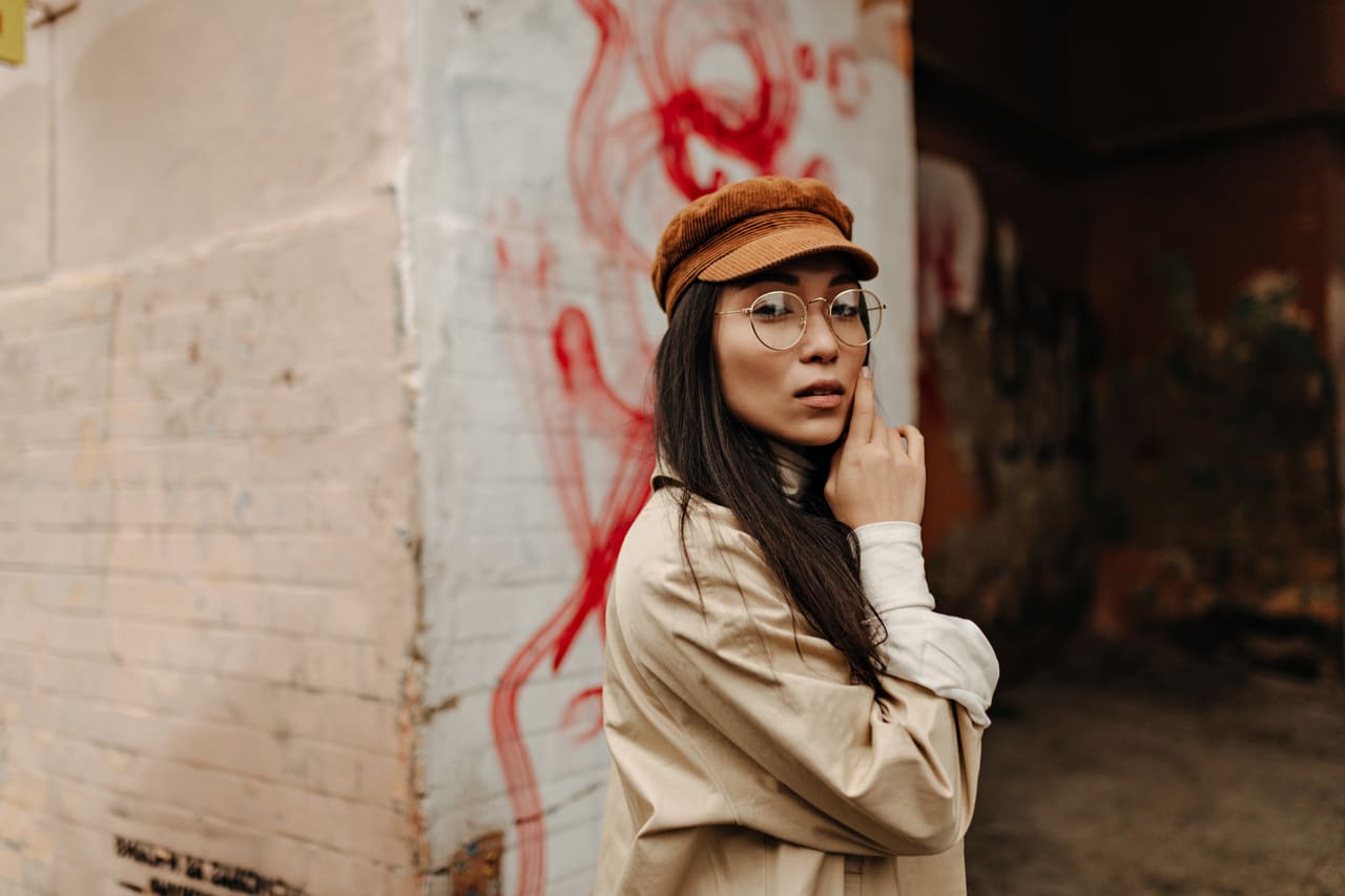 asian girl in cap and coat posing near abandoned h 2022 02 01 22 37 34 utc